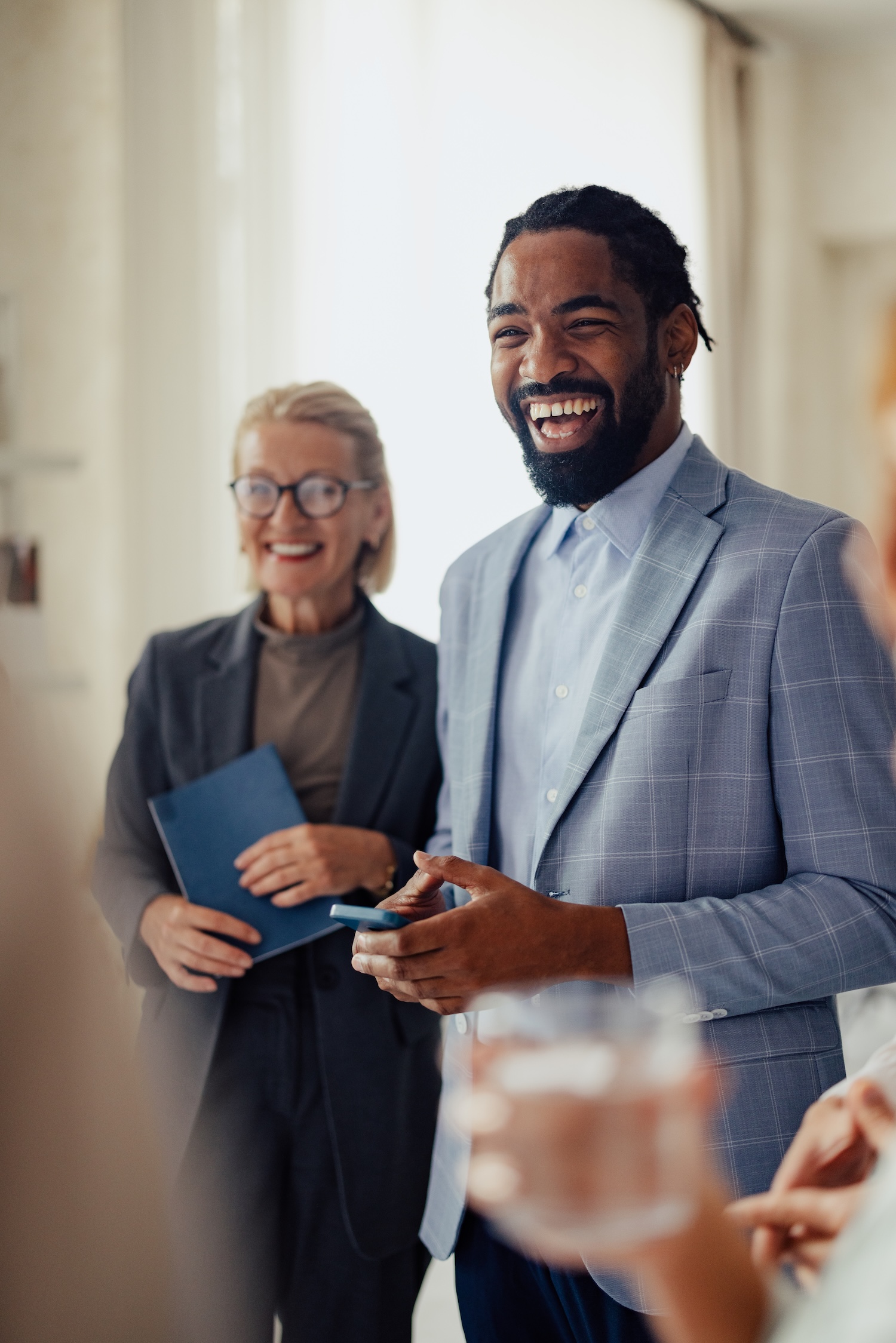Group of people smiling during a business meeting.