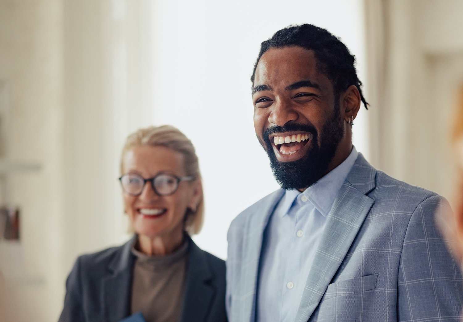 Group of people smiling during a business meeting.