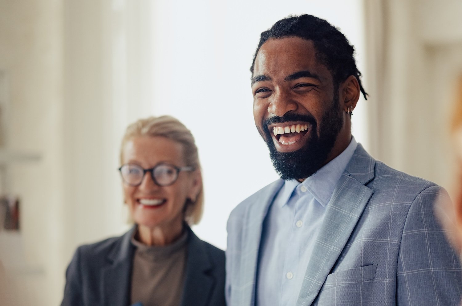 Group of people smiling during a business meeting.